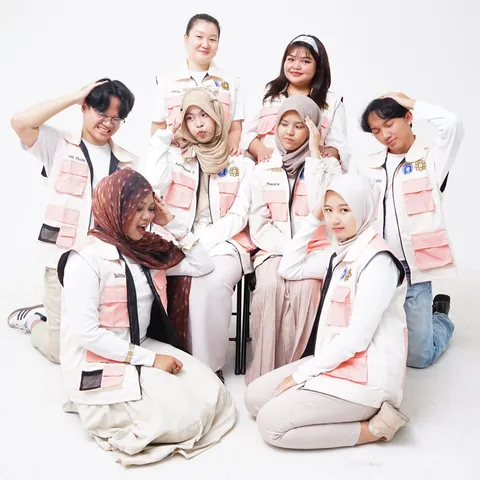 A group of community volunteers posing together in their programme vests