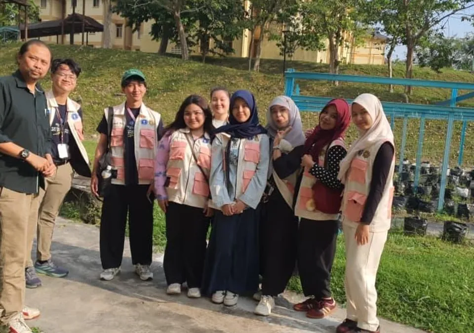 A group of community volunteers and student caretakers gathered at the fertigation frame